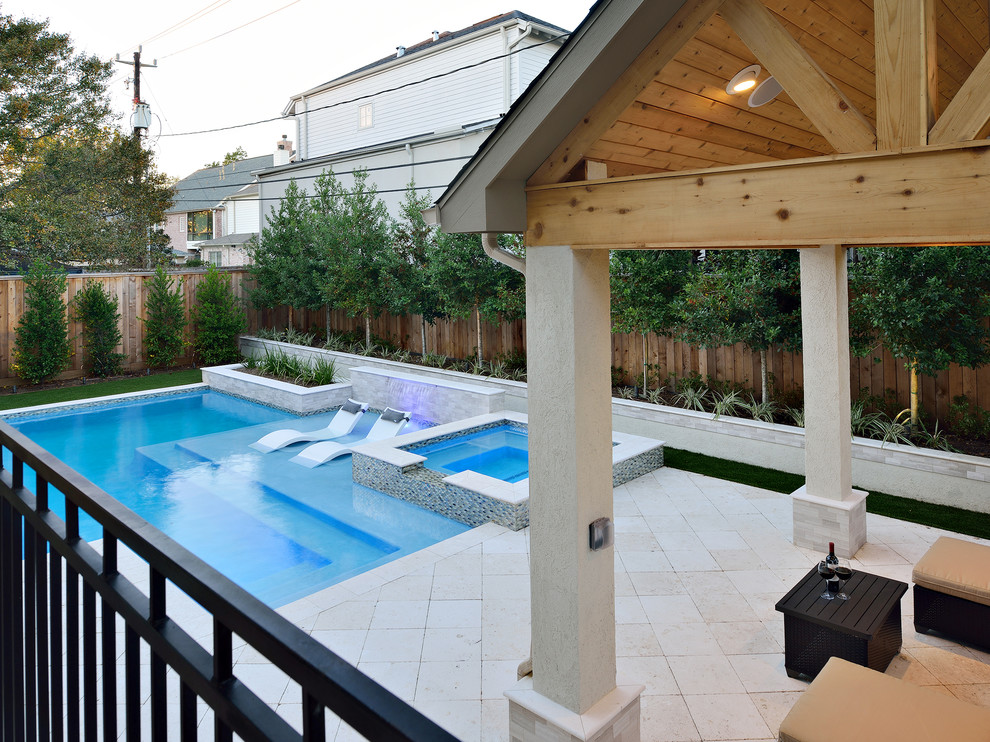 Small contemporary backyard rectangular natural pool in Houston with a hot tub and natural stone pavers.