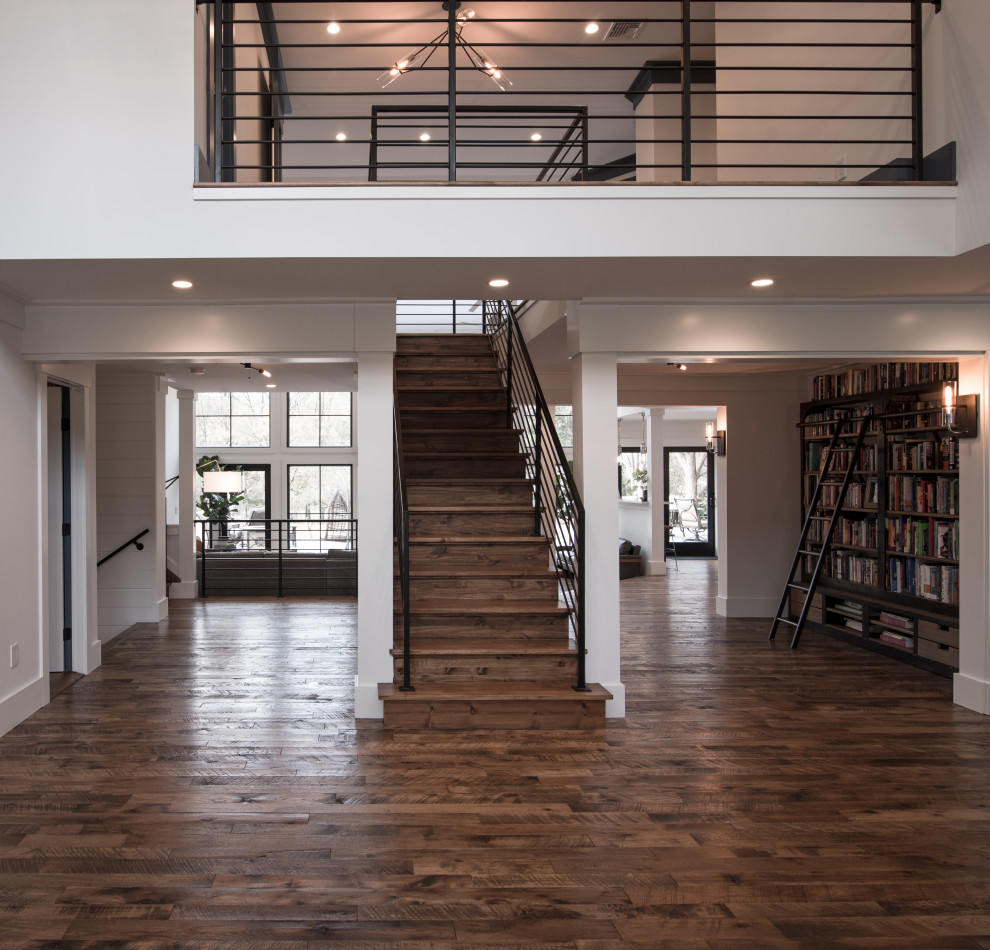 Photo of an expansive modern foyer in New York with dark hardwood floors and brown floor.