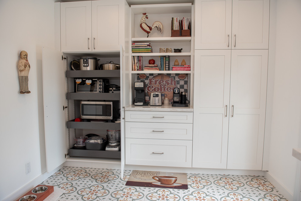 Inspiration for a mid-sized transitional galley kitchen pantry in Miami with an undermount sink, white cabinets, granite benchtops, stainless steel appliances and ceramic floors.