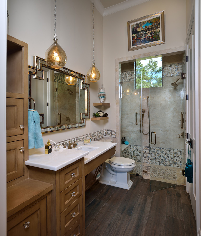 Inspiration for a large eclectic master bathroom in Houston with recessed-panel cabinets, brown cabinets, an alcove shower, a one-piece toilet, beige tile, ceramic tile, beige walls, dark hardwood floors, an undermount sink, marble benchtops, brown floor and a hinged shower door.