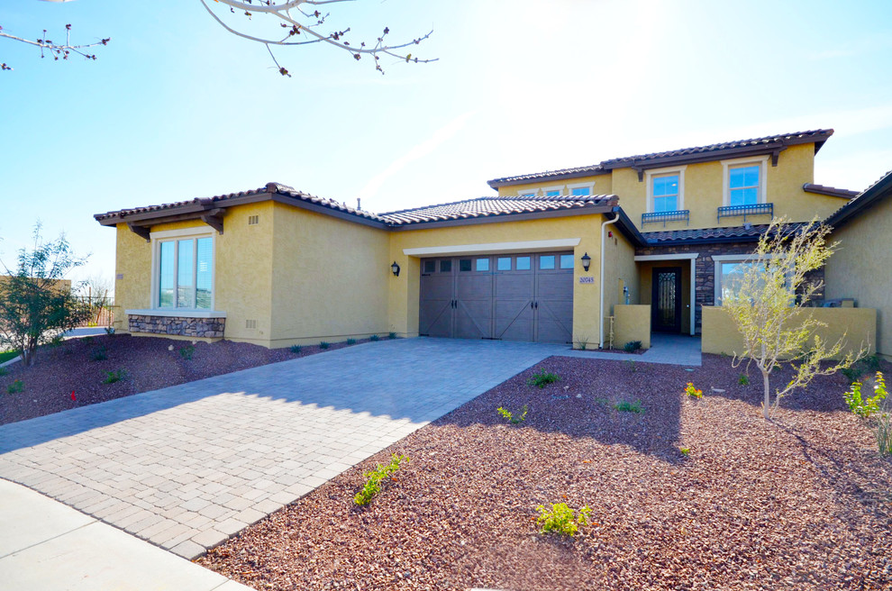 Mid-sized tuscan yellow two-story stucco exterior home photo in Phoenix