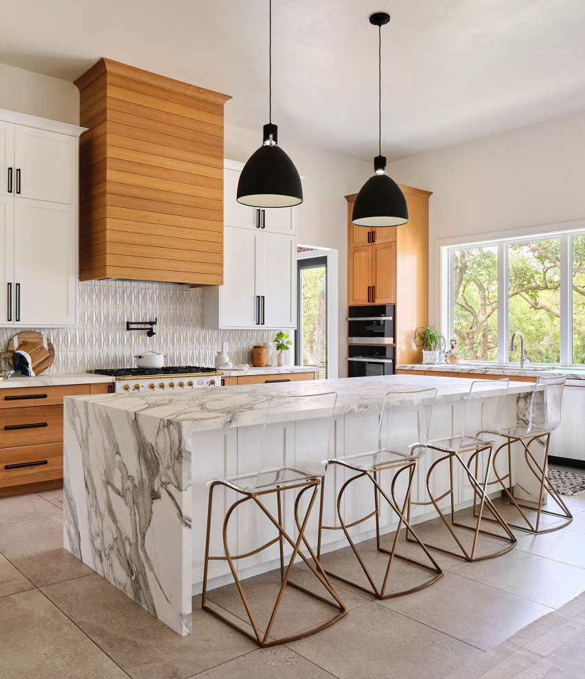 Transitional l-shaped gray floor kitchen photo with white cabinets, an undermount sink, shaker cabinets, white backsplash, white appliances, an island and white countertops