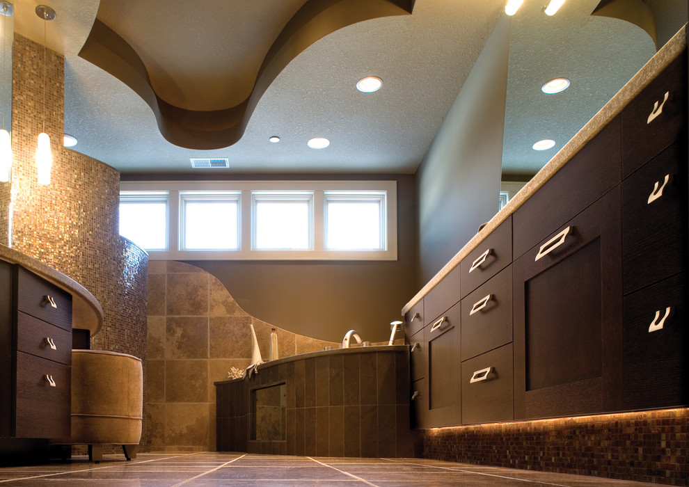 Photo of a large contemporary master bathroom in Minneapolis with flat-panel cabinets, dark wood cabinets, a corner tub, a one-piece toilet, brown tile, ceramic tile, brown walls, ceramic floors and a drop-in sink.