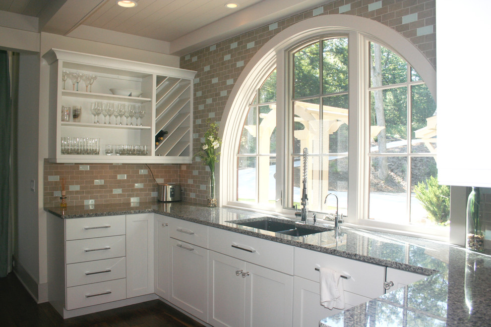 Transitional kitchen in Grand Rapids with an undermount sink, white cabinets and ceramic splashback.
