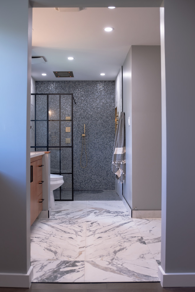 Design ideas for a contemporary master bathroom in Ottawa with flat-panel cabinets, medium wood cabinets, a curbless shower, a bidet, blue tile, grey walls, an integrated sink, white floor, an open shower, a double vanity and a built-in vanity.