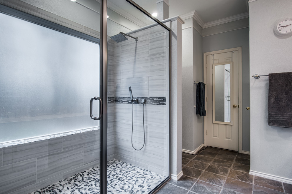 Photo of a mid-sized modern master bathroom in Austin with an alcove shower, gray tile, ceramic tile, grey walls, pebble tile floors, grey floor and a hinged shower door.