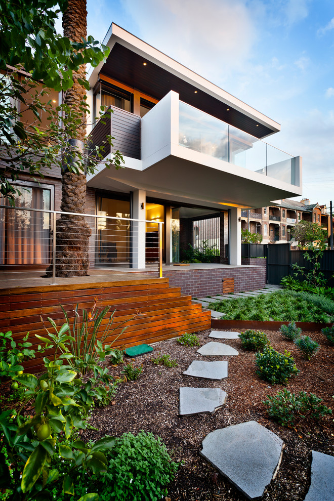 Design ideas for a large contemporary two-storey exterior in Sydney with a flat roof.