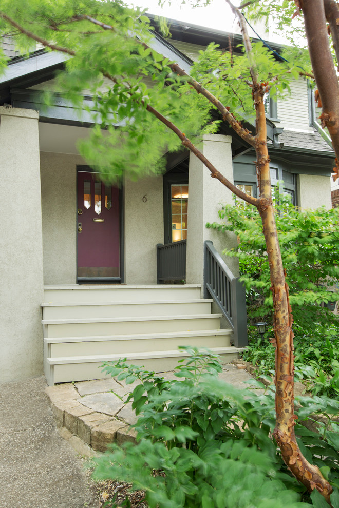 This is an example of a mid-sized contemporary two-storey stucco beige exterior in Toronto.
