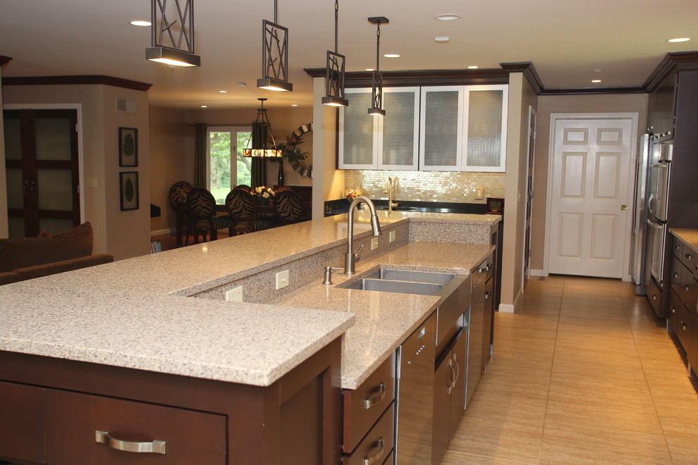 Inspiration for a large transitional galley ceramic tile open concept kitchen remodel in Chicago with an undermount sink, flat-panel cabinets, dark wood cabinets, quartz countertops, gray backsplash, stainless steel appliances, an island and metal backsplash