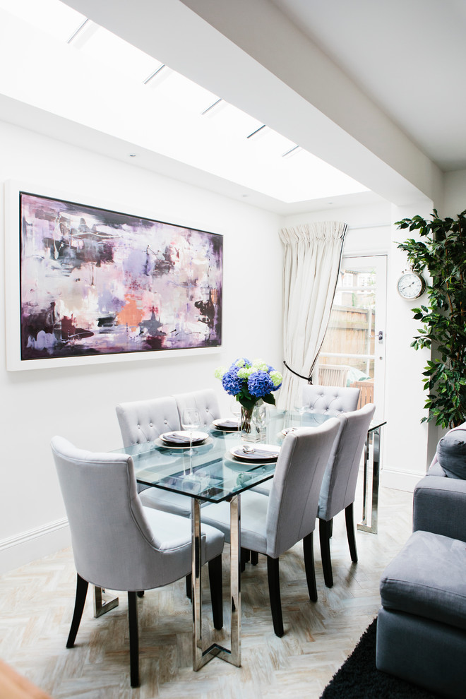 Photo of a large traditional kitchen/dining combo in London with white walls.