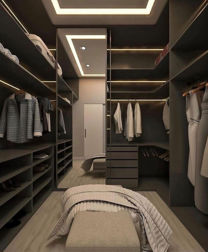 Large modern gender-neutral walk-in wardrobe in Houston with open cabinets, grey cabinets, vinyl floors, grey floor and vaulted.