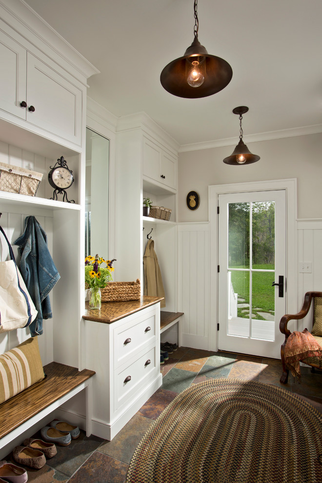 Photo of a country mudroom in Boston with slate floors, a single front door, a glass front door and white walls.