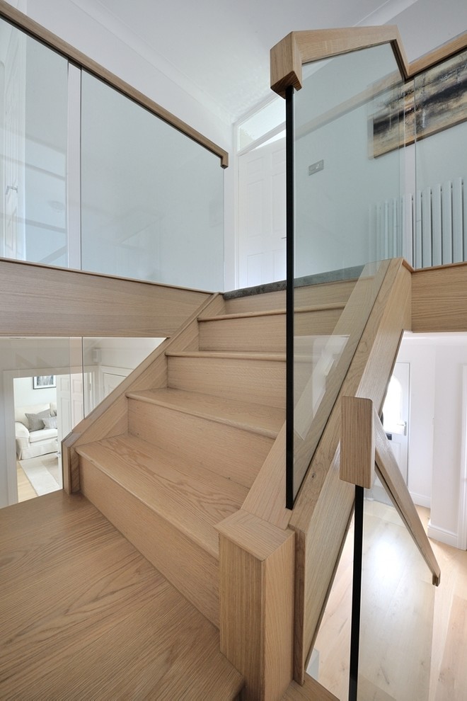 Inspiration for a mid-sized traditional wood curved staircase in Other with wood railing and wood risers.