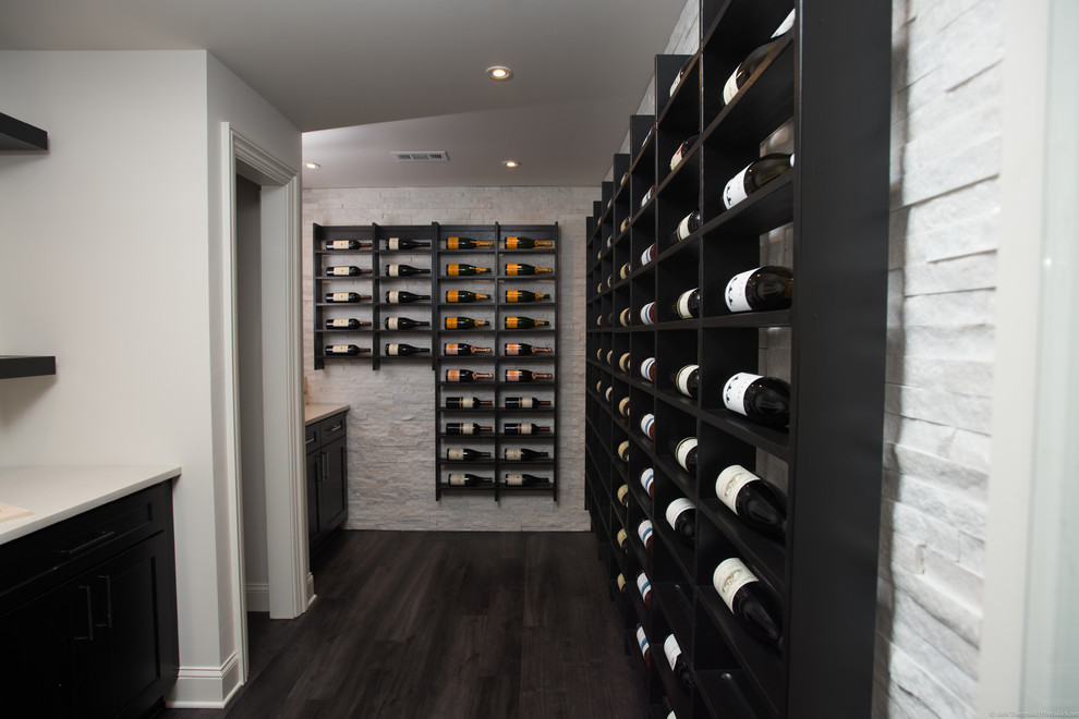 Inspiration for a large modern wine cellar in Atlanta with vinyl floors and display racks.