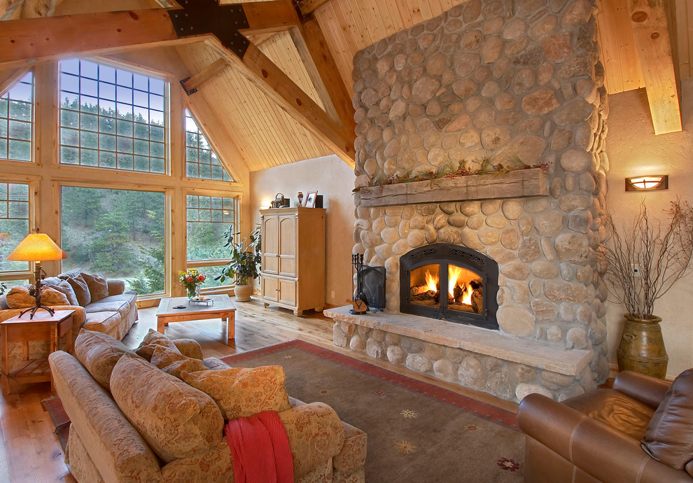 Photo of a large traditional living room in Denver with a standard fireplace and a stone fireplace surround.