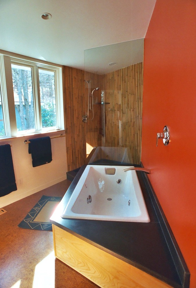 This is an example of a midcentury bathroom in Boston with a drop-in tub, a corner shower, red walls and cork floors.