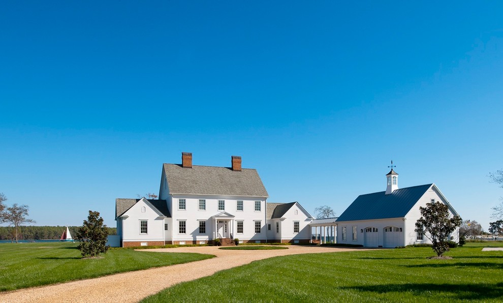 Photo of a large country three-storey white exterior in DC Metro with concrete fiberboard siding and a gable roof.