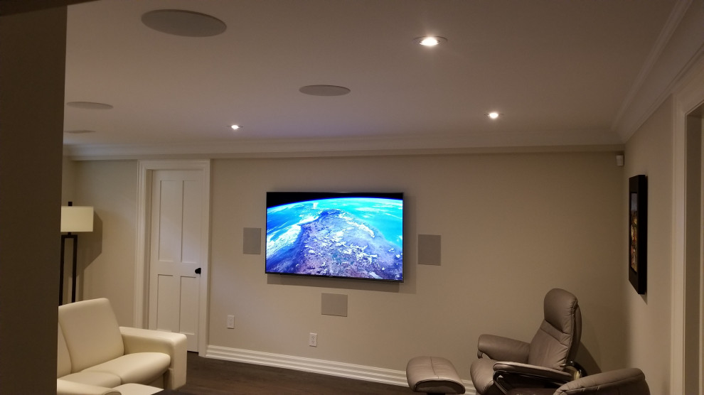 Design ideas for a small contemporary enclosed home cinema in Toronto with dark hardwood flooring and a wall mounted tv.