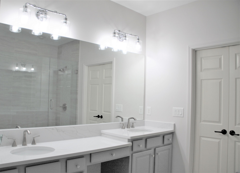 This is an example of a large shabby-chic style ensuite bathroom in Atlanta with raised-panel cabinets, black cabinets, a walk-in shower, multi-coloured tiles, mosaic tiles, a submerged sink, marble worktops, multi-coloured floors, a hinged door, white worktops, a shower bench, double sinks and a built in vanity unit.