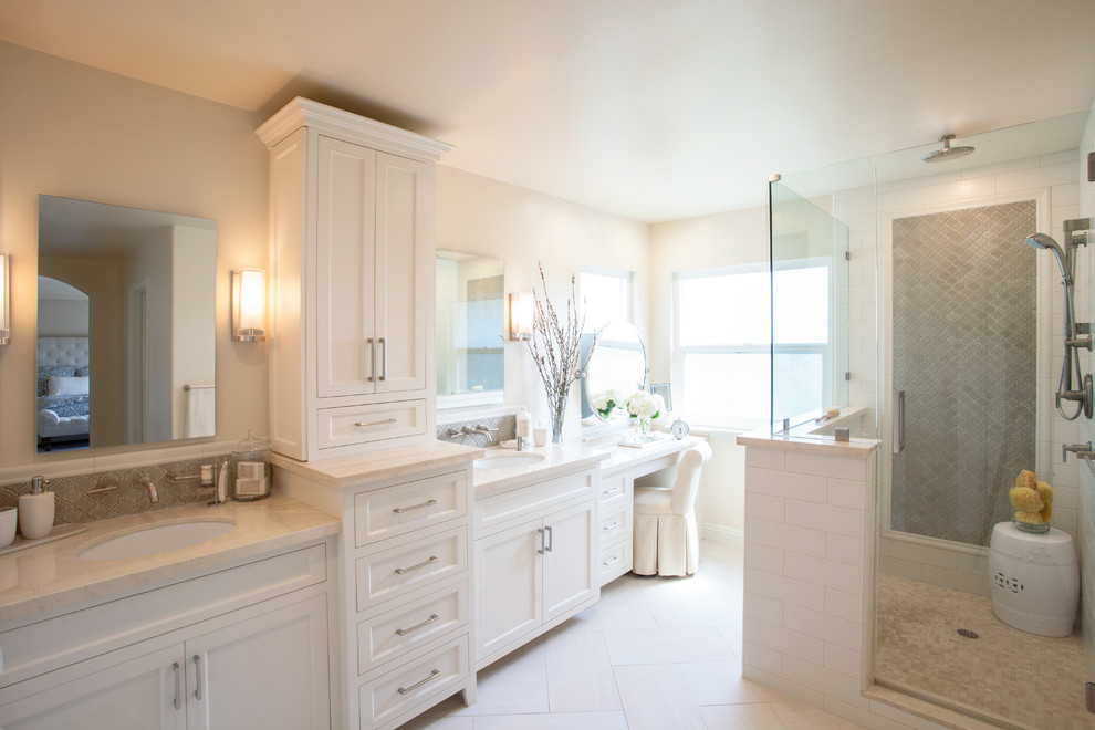 Design ideas for a large transitional master bathroom in San Diego with an undermount sink, recessed-panel cabinets, white cabinets, marble benchtops, a corner shower, a one-piece toilet, white tile, ceramic tile, white walls and porcelain floors.