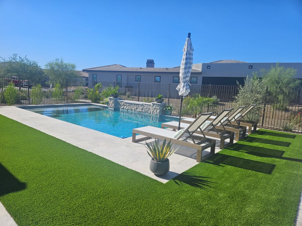Example of a mid-sized transitional stone and rectangular pool design in Phoenix