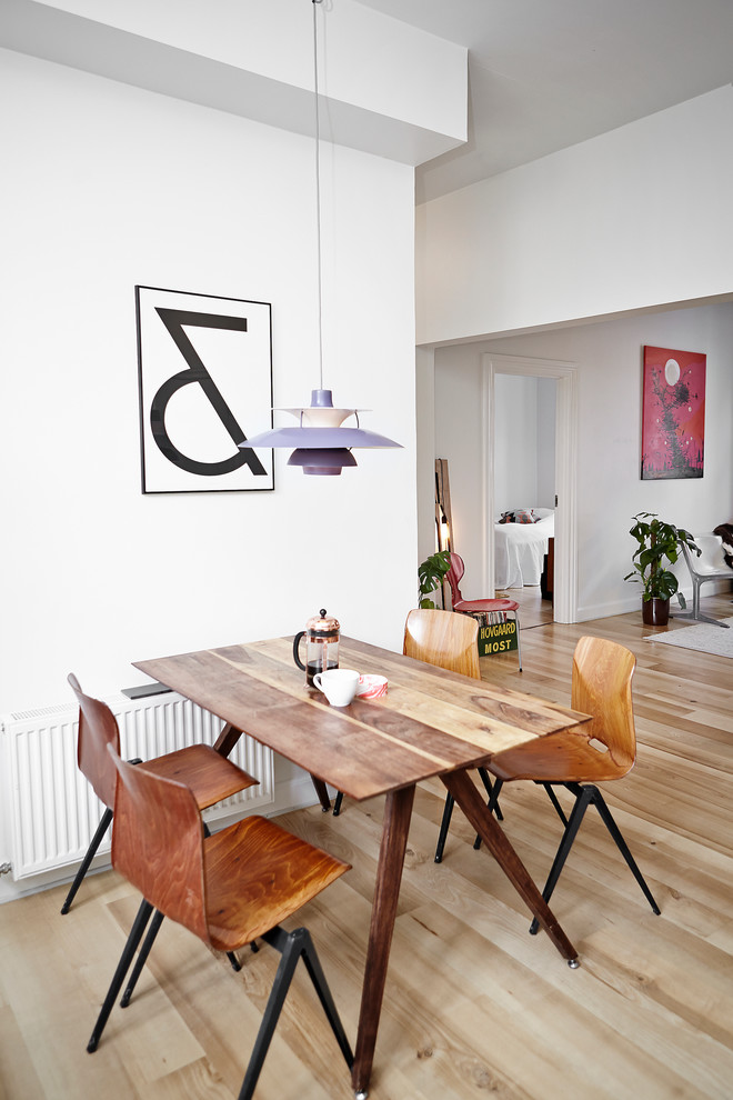Photo of a mid-sized scandinavian separate dining room in Aarhus with white walls, light hardwood floors and no fireplace.