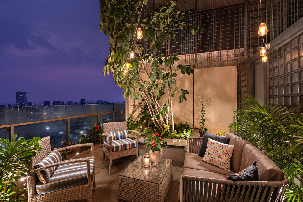 Photo of a contemporary balcony in Mumbai with feature lighting.