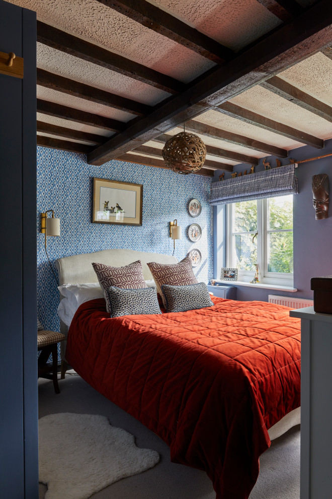 На фото: спальня в стиле фьюжн с синими стенами, ковровым покрытием, серым полом, балками на потолке и обоями на стенах с