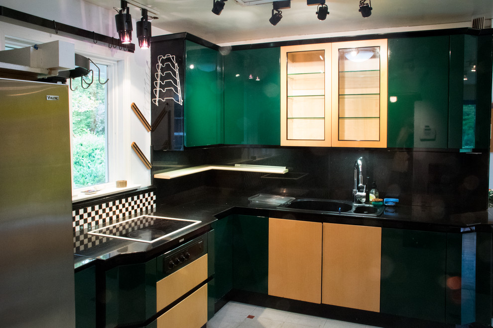 Small contemporary u-shaped separate kitchen in New York with a double-bowl sink, flat-panel cabinets, green cabinets, marble benchtops, black splashback, stone slab splashback and linoleum floors.