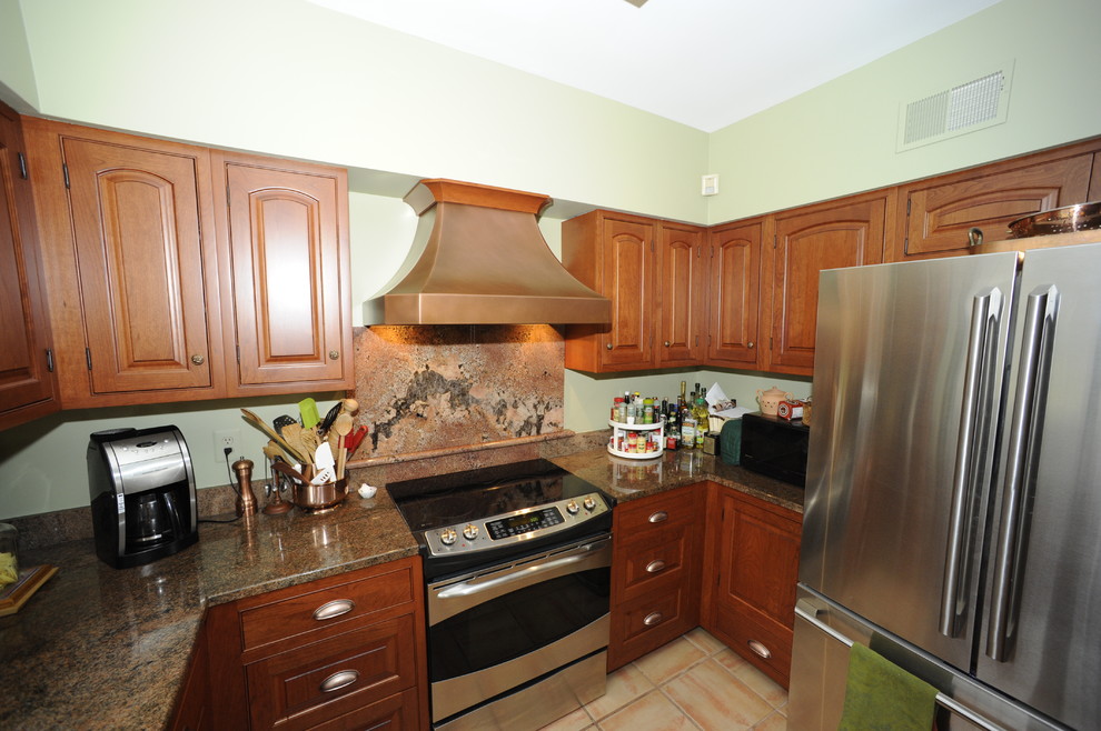 Example of a mid-sized transitional u-shaped limestone floor enclosed kitchen design in Baltimore with an undermount sink, beaded inset cabinets, dark wood cabinets, granite countertops, beige backsplash, stone tile backsplash, stainless steel appliances and a peninsula