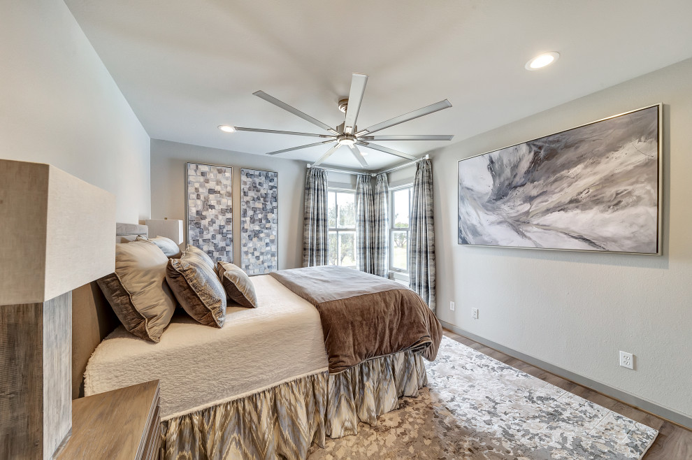 Photo of a large contemporary guest bedroom in Dallas with grey walls, medium hardwood floors and brown floor.