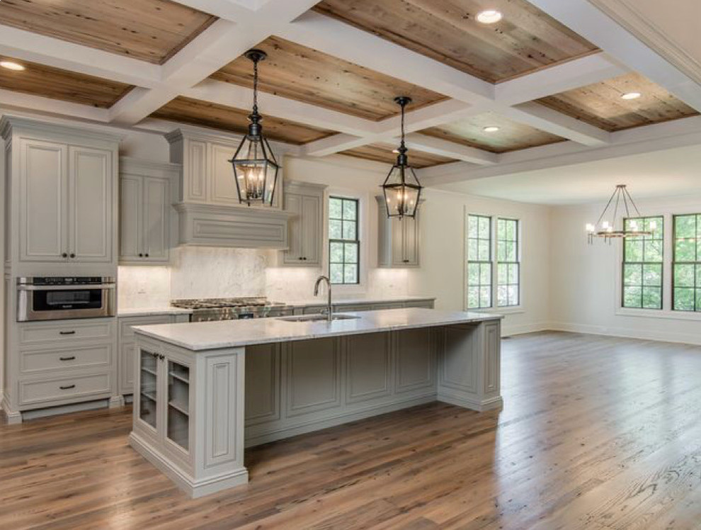 Large transitional l-shaped medium tone wood floor and brown floor open concept kitchen photo in Phoenix with an undermount sink, beaded inset cabinets, gray cabinets, quartz countertops, white backsplash, marble backsplash, stainless steel appliances, an island and white countertops