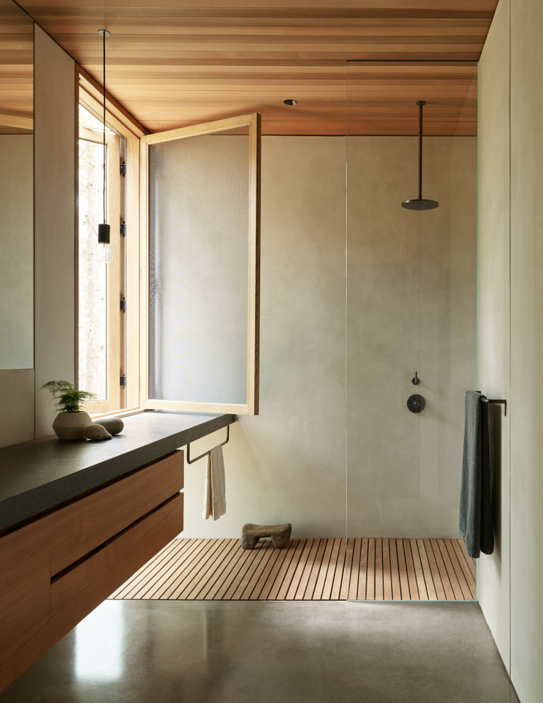 Inspiration for a modern bathroom in Seattle with flat-panel cabinets, concrete floors, granite benchtops, medium wood cabinets, a curbless shower, gray tile, grey floor, an open shower, grey benchtops, a floating vanity and wood.