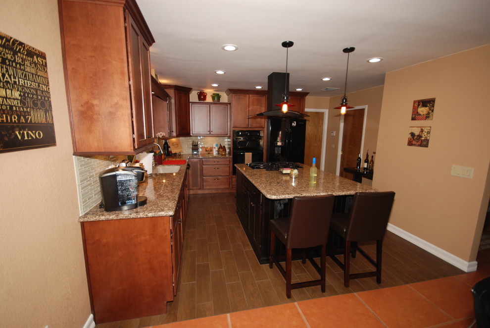 Elegant u-shaped eat-in kitchen photo with an undermount sink, shaker cabinets, brown cabinets, quartz countertops, beige backsplash, glass sheet backsplash and black appliances