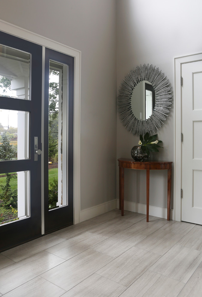 Mid-sized transitional front door in New York with grey walls, travertine floors, a single front door and a glass front door.