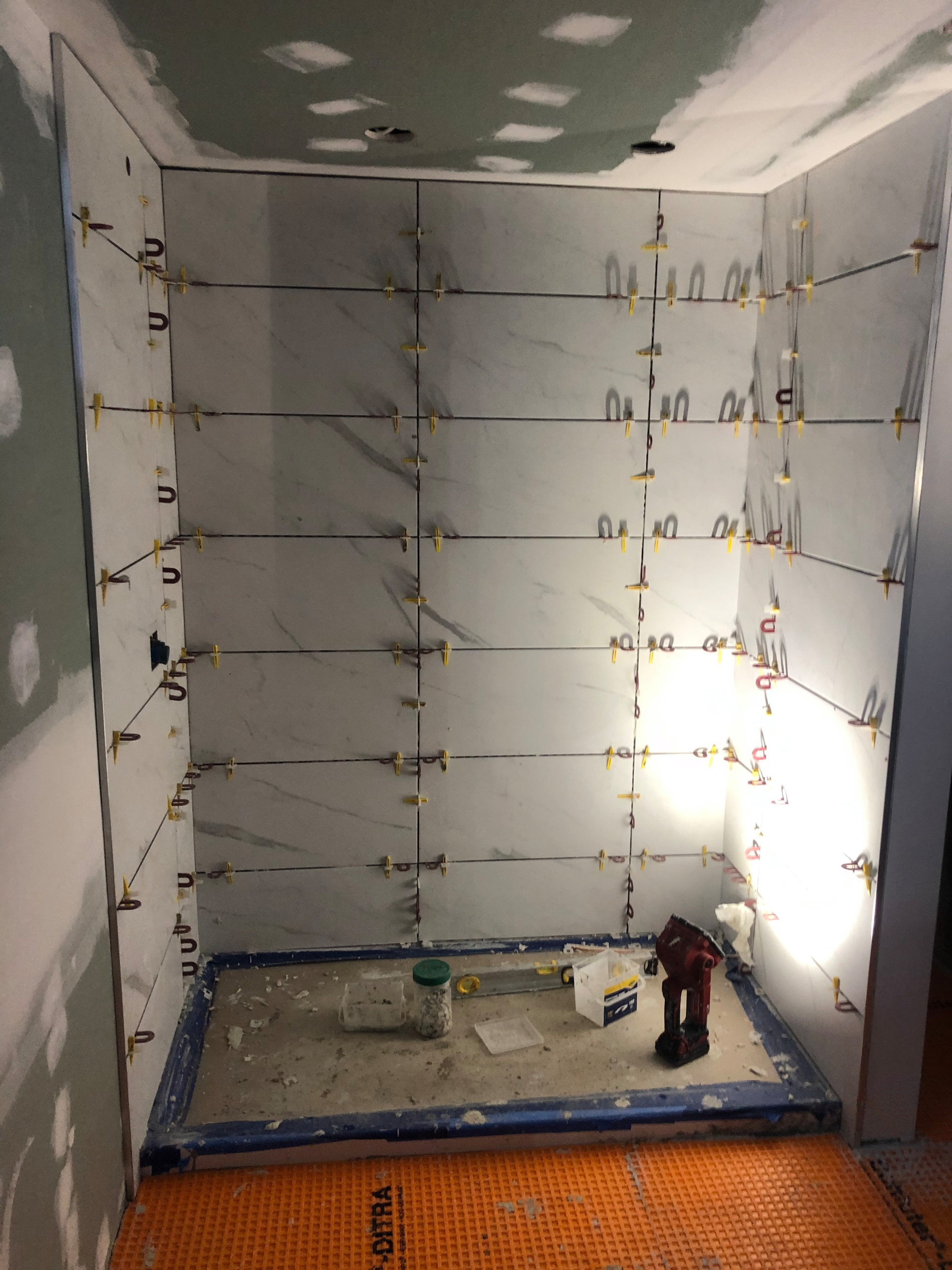 Tile install process including under tile waterproofing
