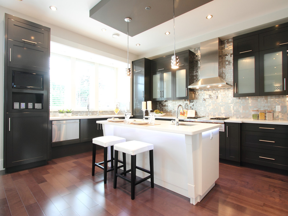 Photo of a contemporary kitchen in Vancouver with glass-front cabinets, black cabinets, metallic splashback and metal splashback.