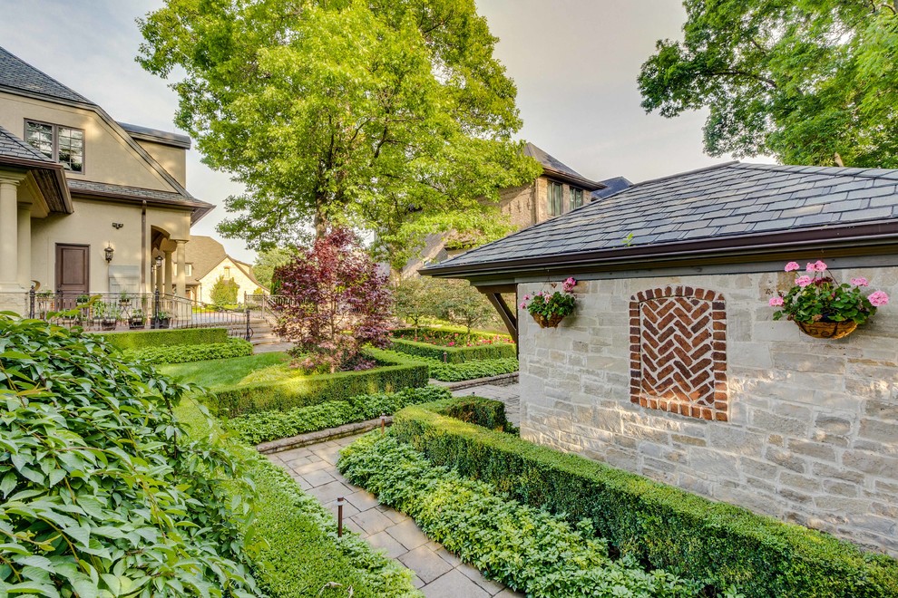 Inspiration for a large traditional backyard full sun formal garden for spring in Detroit with a garden path and natural stone pavers.