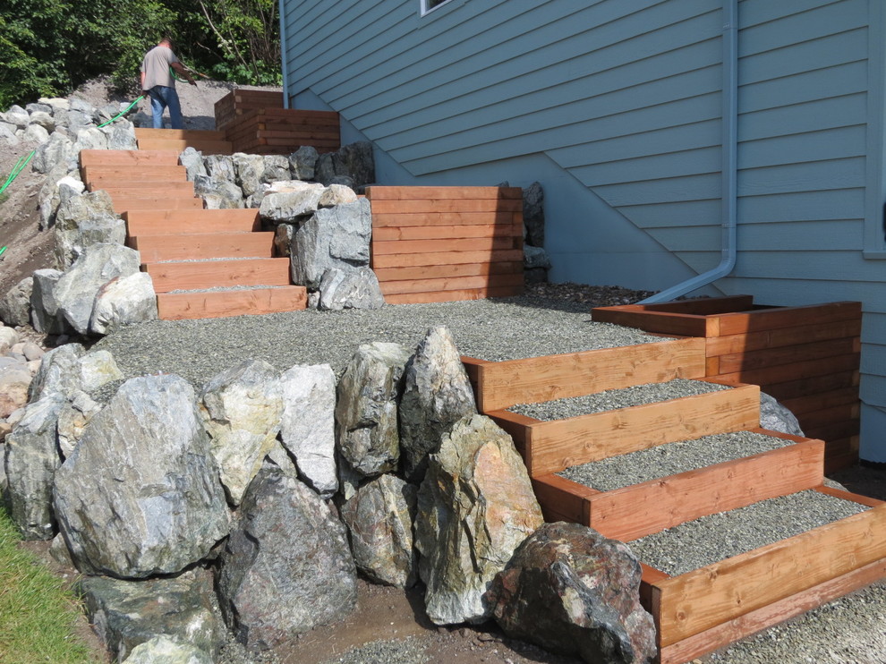 Design ideas for a full sun side yard retaining wall landscape.