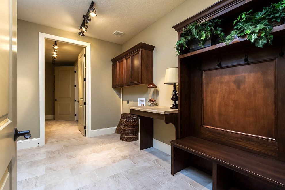Photo of a large transitional utility room in Chicago with brown walls, ceramic floors and beige floor.