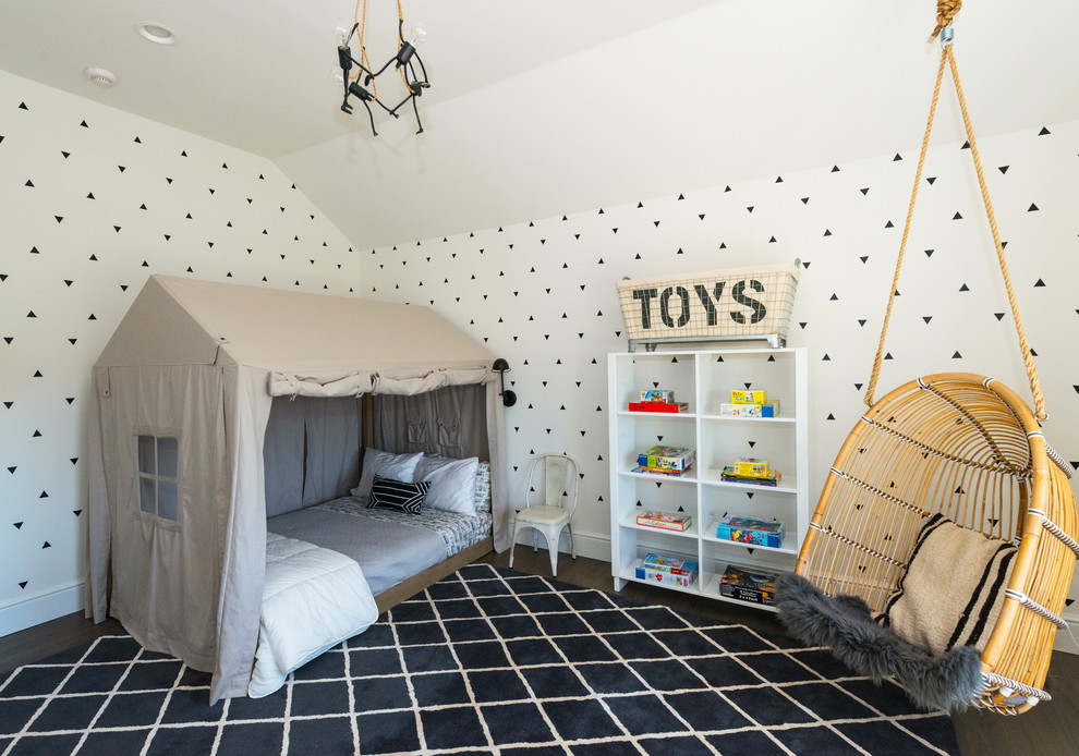 This is an example of a transitional kids' bedroom for kids 4-10 years old and boys in New York with white walls, dark hardwood floors and brown floor.