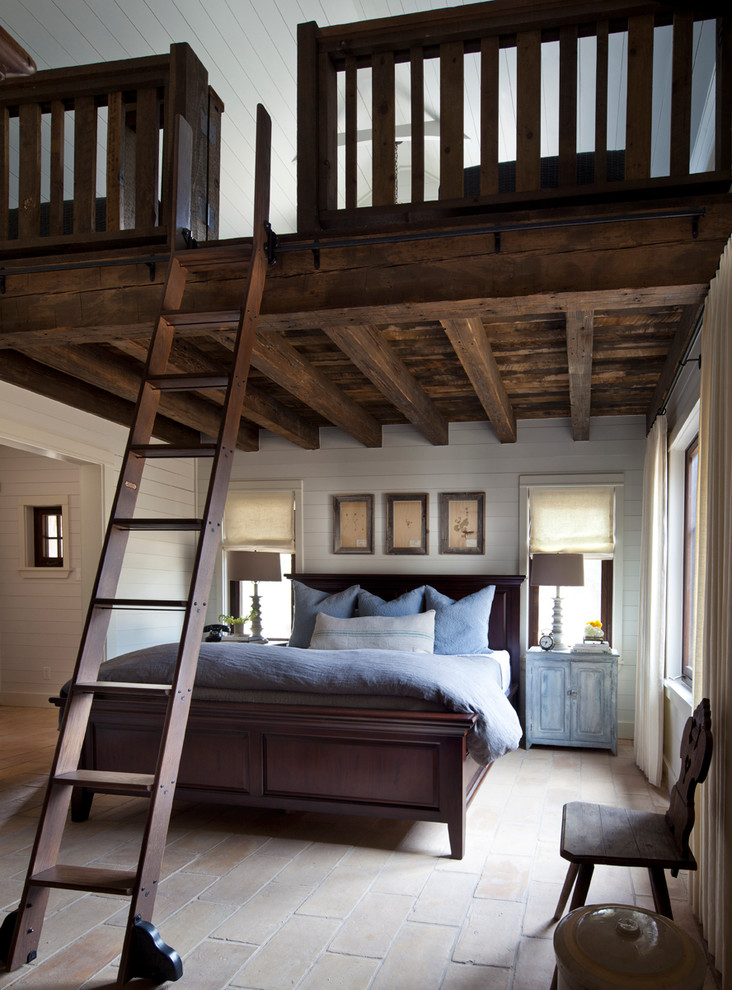 This is an example of a country bedroom in Austin with white walls.