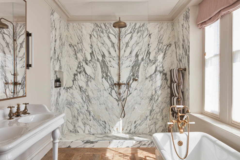 Inspiration for a large traditional kids bathroom in London with white cabinets, a freestanding tub, an open shower, black and white tile, marble, white walls, medium hardwood floors, a pedestal sink, marble benchtops, brown floor, an open shower, white benchtops, a niche, a double vanity and a freestanding vanity.