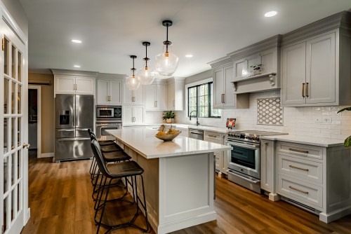 Cost effective RTA cabinets in a modern Canadian kitchen with white shaker style and island