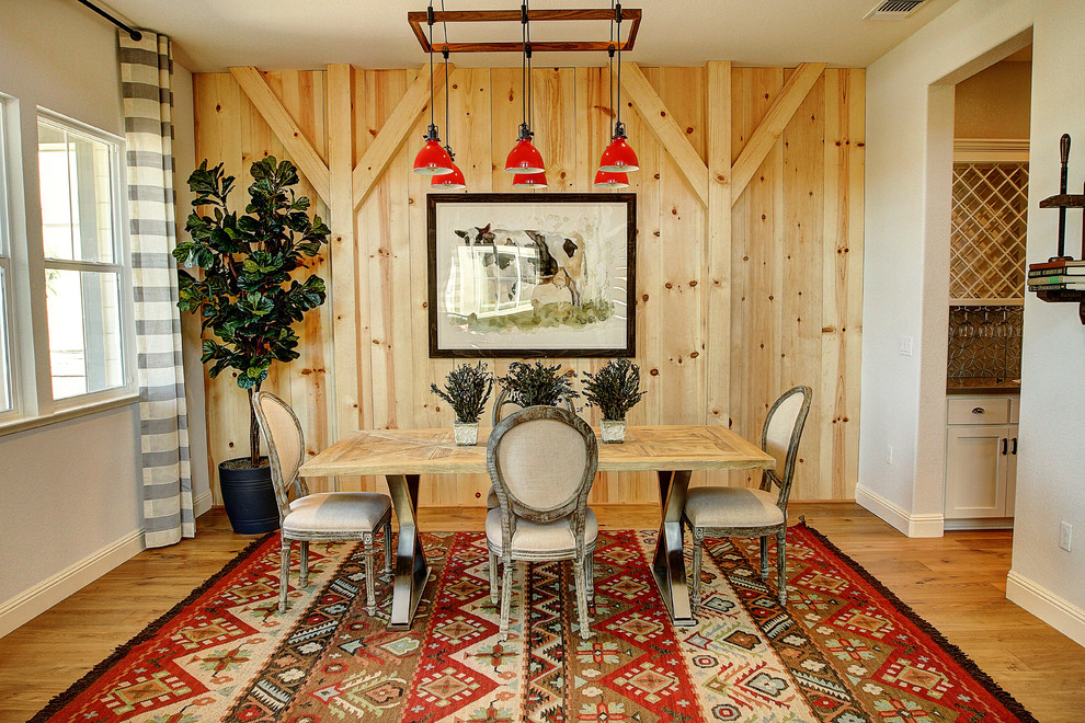 This is an example of a mid-sized country dining room in San Francisco with light hardwood floors.