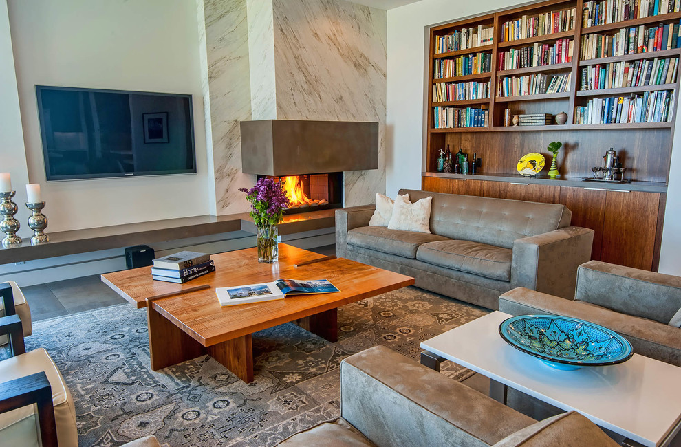 This is an example of a contemporary family room in Los Angeles with white walls, a standard fireplace, a stone fireplace surround and a wall-mounted tv.