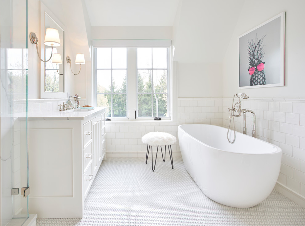 Inspiration for a transitional master bathroom in Chicago with recessed-panel cabinets, white cabinets, a freestanding tub, white tile, white walls and white floor.