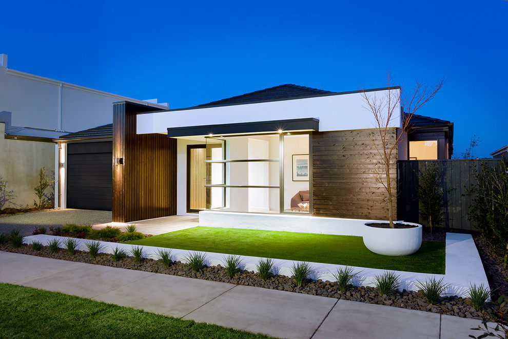 Photo of a large contemporary one-storey brick white exterior in Melbourne.