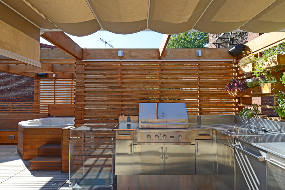 This is an example of a small modern rooftop deck in DC Metro with an outdoor kitchen and a pergola.