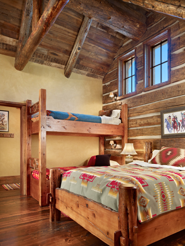 Inspiration for a mid-sized country guest bedroom in Other with yellow walls and medium hardwood floors.